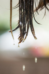 Wet hair ends. oil or water falling down from hair ends.