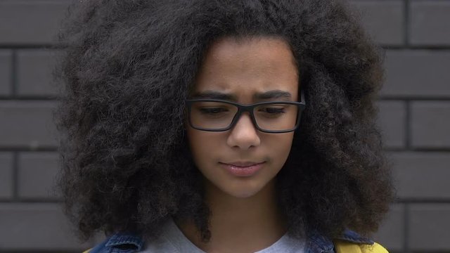 Teen biracial girl suffers teasing about clothes and hair, appearance bullying