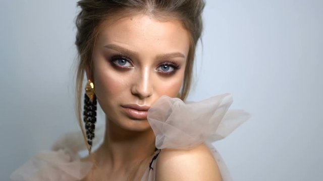 Beauty portrait of model face with bright blue eyes skin care concept.