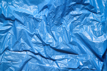 Blue plastic bag texture background. Waste recycling concept. Crumpled polyethylene and cellophane.