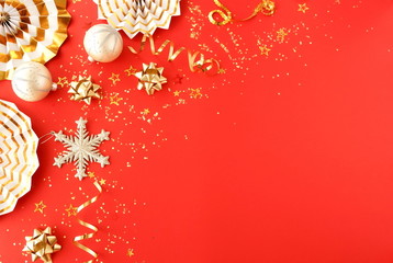 christmas or new year frame decorations in gold colors on red color background with empty copy space for text. Xmas, holiday and celebration concept for postcard or invitation. top view 