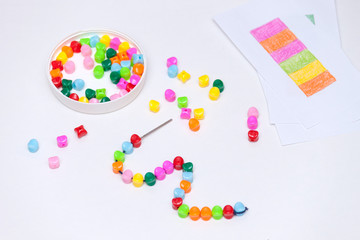 Plastic multicolored beads. Homemade game for children development concept.