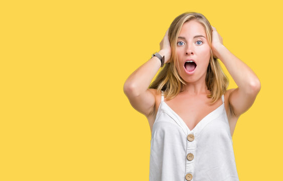 Beautiful young woman over isolated background Crazy and scared with hands on head, afraid and surprised of shock with open mouth