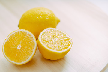 Fototapeta na wymiar lemon slices on wood with a white background