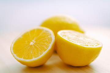 lemon slices on wood with a white background