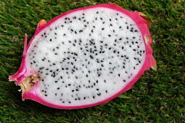 White dragon fruit or pitaya on the grass.