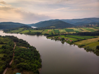 Aerial view of lake, forest and agriculture field by the water, at summer. Gruza lake near the Kragujevac in Serbia.