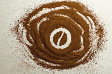 Coffee bean paint in coffee powder on textured background