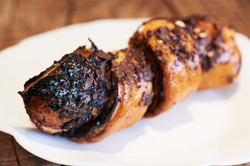 Chocolate french croissant on a white plate. Home baked puff pastry rolls