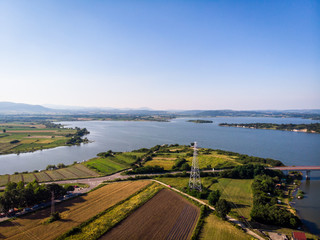 Aerial view of lake, forest and agriculture field by the water, at summer. Gruza lake near the Kragujevac in Serbia.