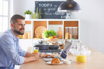 a business man breakfasts with notebook and juice