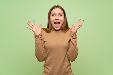 Young woman with turtleneck sweater with shocked facial expression