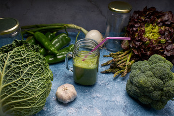view of a pitcher of tasty green smoothie of fresh vegetables for vegans