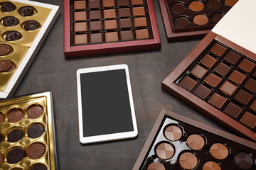 Boxes of chocolate with digital tablet