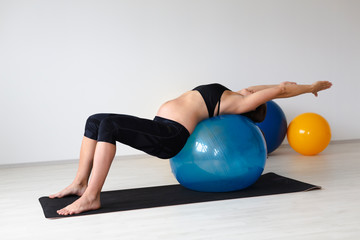 beautiful, young, fit, athletic and pregnant woman with black hair doing fitness exercises in a modern apartment, Tulln, Lower Austria