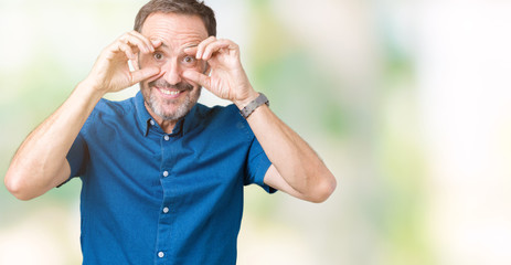 Naklejka premium Handsome middle age elegant senior man over isolated background Trying to open eyes with fingers, sleepy and tired for morning fatigue