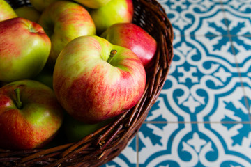 basket of apple on kitchen tile floor