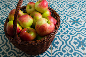 basket of apple on kitchen tile floor