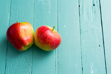 two apples on blue wooden background