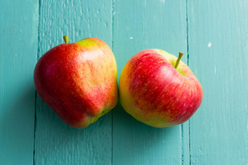 two apples on blue wooden background
