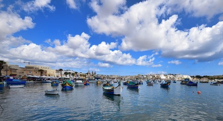 Fototapeta na wymiar Fishing boats in the harbour of Marsaxlokk