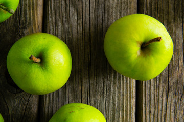green apples on old wooden background