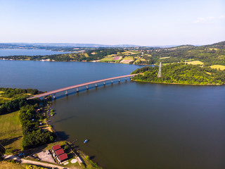 Fototapeta premium Aerial view of lake, forest and agriculture field by the water, at summer. Gruza lake near the Kragujevac in Serbia.
