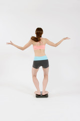 Fototapeta premium 体重計に乗りガッカリする女性