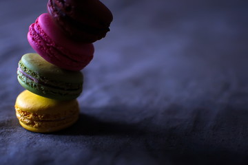 Multi-colored macaroons on a wooden tray. Pink, yellow and green macaroon. - 278224708