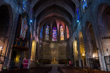Esglesia de Santa Maria del PI, detail of the central nave with golden chapels and polychrome stained glass windows. Barcelona.
