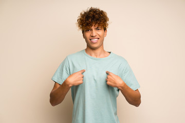 African american man with green shirt with surprise facial expression
