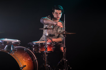 Fototapeta premium musician playing drums, black background and beautiful soft light