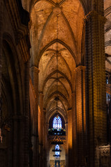 Fototapeta premium The Cathedral of Barcelona, detail of the lateral nave in typical gothic style with elegant side niches. Barri Gotic, Barcelona.
