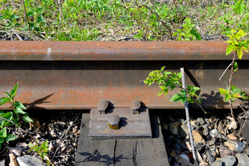 Old rusty rails of an abandoned railway. Side view