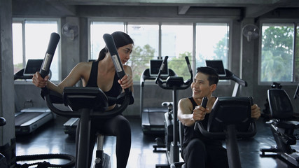 Concept of physical exercise Teens are cycling to lose weight in the gym.