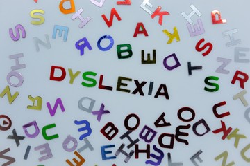 Dyslexia in a sea of random letters. Creative concept : reading disability