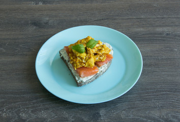 Sandwich with bread, red fish, cottage cheese, scramble and quail eggs
