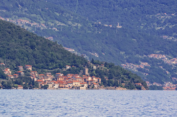 Fototapeta na wymiar Rezzonico, a medieval village observed from the boat during the crossing of Como Lake, Lombardy. Italy
