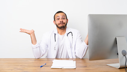 Doctor Colombian man having doubts while raising hands
