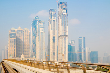 Fototapeta premium Dubai skyline from Dubai Metro train, in Dubai, United Arab Emirates