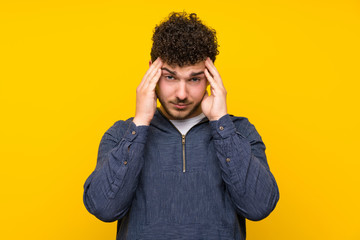 Young man over isolated yellow wall unhappy and frustrated with something. Negative facial expression