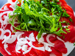 Greek salad with rucola on stone table
