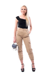 Happy young blonde woman with handbag wearing military ocker pants posing.  Full body isolated on white background.