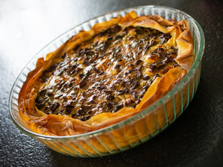 Tart with mushrooms on stone table