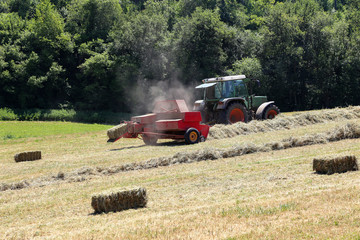 A baler in the fields during the harvesting process