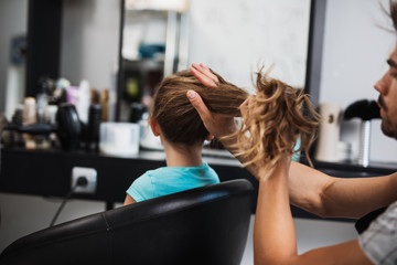 Beautiful hairstyle of cute girl  in hair salon.