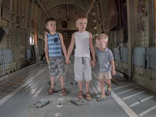 Fototapeta premium Happy kids in cargo hold of heavy army helicopter