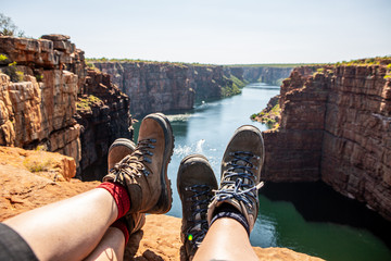 hiking on the King George River Gorge and plateau in the Kimberleys  with lush bushes and sandstone...