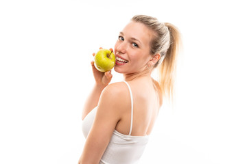 Obraz na płótnie Canvas Young blonde woman over isolated white background with an apple