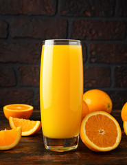 Orange juice in glass on rustic wooden table